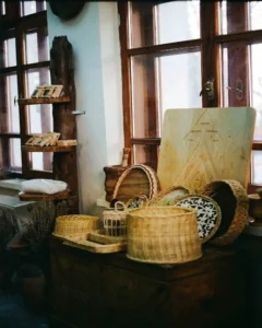 woven wicker baskets on the top shelves of an open kitchen pantry cabinet