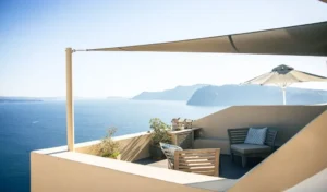 small balcony with shade sail blocking direct summer sun