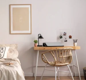 desk placed beside the bed in place of a nightstand
