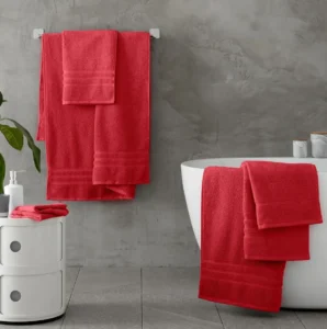 folded red towels bathroom shelf