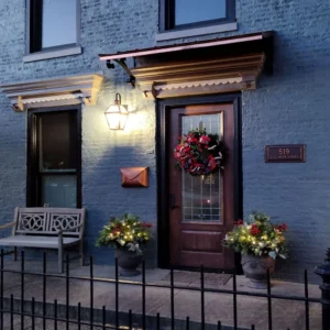 front porch christmas decor with wreath and warm lantern lighting