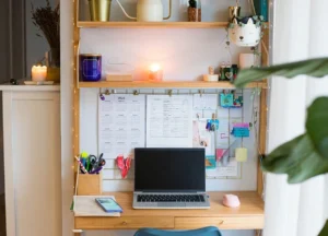 small desk with vertical shelving and a pegboard above it